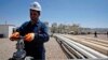 FILE - An employee works at Tawke oil fields in northern Iraq's Kurdish region.