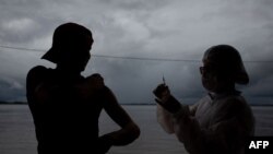 A resident is vaccinated against COVID in Anama town, Amazon, Brazil on May 20, 2021. 