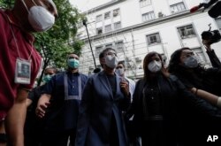 FILE - Rappler CEO and Executive Editor Maria Ressa, center, is escorted after attending her hearing in Manila, Philippines on Monday June 15, 2020. Ressa,