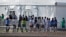 FILE - Children line up to enter a tent at a shelter for migrant children in Homestead, Fla., Feb. 19, 2019. A Biden administration effort to reunite children and parents separated under then-President Donald Trump's zero-tolerance border policy has made increasing progress.