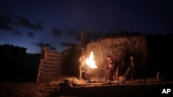 Une famille palestinienne devant sa maison lors d'une coupure de courant à Khan Younis dans la bande de Gaza, le 15 janvier 2017.