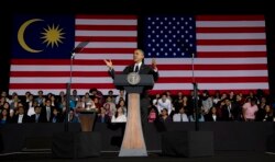 FILE - President Barack Obama gestures as he speaks during a town hall meeting at Malaya University in Kuala Lumpur, Malaysia, Sunday, April 27, 2014.