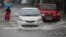 Vehicles navigate their way through a flooded street in Mumbai, India, Sept. 20, 2017. Incessant rainfall in India's commercial capital has affected air and rail traffic.