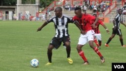 Highlanders striker Kasimero Chimbadzwa shields the ball from Chicken Inn defender Divine Lunga.