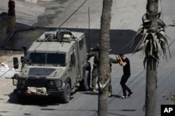 Israeli soldiers arrest a Palestinian man during a military operation in Jenin, West Bank, Sept. 5, 2024.