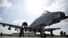 FILE - U.S. military personnel stand beside an A-10C fighter at Kandahar Airfield, Afghanistan, Jan. 23, 2018.