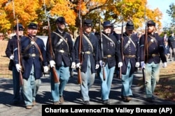 Civil War re-enactors participate in ceremonies during funeral services, Oct. 16, 2024, for the burial of the cremated remains of Byron R. Johnson, a Union soldier who fought in the Civil War, at Oak Grove Cemetery in Pawtucket, Rhode Island.