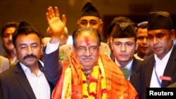 Nepal's newly elected Prime Minister Pushpa Kamal Dahal, also known as Prachanda, waves towards the media after he was elected Nepal's 24th prime minister in 26 years, in Kathmandu, Nepal, August 3, 2016.
