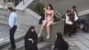 This image grab from a UGC video posted on Nov. 2, 2024, and widely shared on social media shows a female student in her underwear outside Tehran's Islamic Azad University.