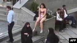 This image grab from a UGC video posted on Nov. 2, 2024, and widely shared on social media shows a female student in her underwear outside Tehran's Islamic Azad University.