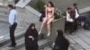 This image grab from a UGC video posted on Nov. 2, 2024, and widely shared on social media shows a female student in her underwear outside Tehran's Islamic Azad University.