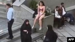 This image grab from a UGC video posted on Nov. 2, 2024, and widely shared on social media shows a female student in her underwear outside Tehran's Islamic Azad University.