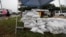 A man, far left, sells sandbags as Hurricane Isaias approaches, in Wilmington, North Carolina, Aug. 3, 2020.