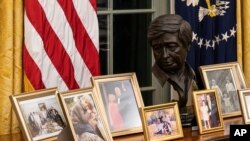 FILE - This Wednesday, Jan. 20, 2021, file photo shows the newly redecorated Oval Office of the White House in Washington. Paul Chavez had no idea where a sculpture of his father, Latino American civil rights and labor leader Cesar Chavez, would end…