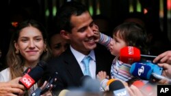 Pemimpin oposisi Venzuela Juan Guaido bersama istrinya (Fabiana Rosales) putrinya Miranda saat memberikan pernyataan kepada media di Caracas, Kamis (31/1). 