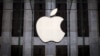 FILE - An Apple logo hangs above the entrance to the Apple store on 5th Avenue in the Manhattan borough of New York City, July 21, 2015. 