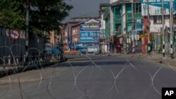 A barbwire blocks a deserted street on the first anniversary of India’s decision to revoke the disputed region’s semi-autonomy, in Srinagar, Indian controlled Kashmir, Aug. 5, 2020.