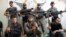 Free Syrian Army fighters pose for a photograph with their weapons in the old city of Aleppo, Sept. 16, 2013.
