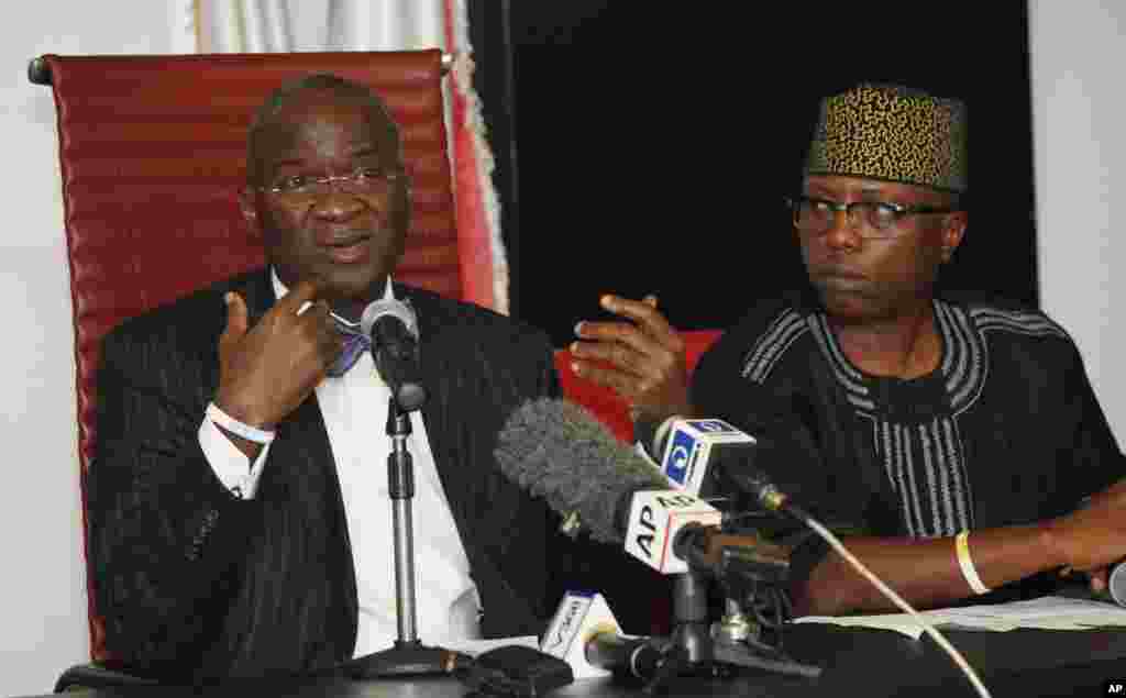 Lagos state Governor Babatunde Raji Fashola, left, speaks as commissioner for special duty, Wale Ahmed looks on during a presentation of medical protective kits for Ebola treatment centers.Lagos, Nigeria, Sept. 1, 2014.