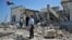 People inspect the damage done to a Sufi shrine, the tomb of Sidi Mohamed Landoulsi, after an explosion in the Tajoura neighborhood on the outskirts of Tripoli, March 28, 2013. 