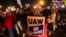 Members of the UAW (United Auto Workers) picket and hold signs outside of the UAW Local 900 headquarters across the street from the Ford Assembly Plant in Wayne, Michigan on September 15, 2023.