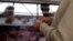 FILE - A man counts money to pay for goods at the Granada market in Mexico City, Jan. 10, 2017. 
