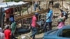 FILE - Residents of the Nazon neighborhood displaced by gang violence construct a tent encampment, in Port-au-Prince, Haiti, Nov. 15, 2024.