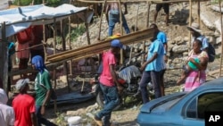 FILE - Residents of the Nazon neighborhood displaced by gang violence construct a tent encampment, in Port-au-Prince, Haiti, Nov. 15, 2024.