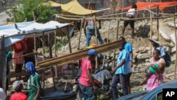 FILE - Residents of the Nazon neighborhood displaced by gang violence construct a tent encampment, in Port-au-Prince, Haiti, Nov. 15, 2024.