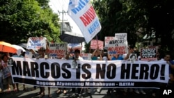 Philippines Marcos Burial: Anti-Marcos protesters holds slogans in a rally outside the Philippine Supreme Court in Manila, Philippines to coincide with the oral arguments following petitions filed by various civil society groups opposing the hero's burial of the late strongman Ferdinand Marcos at the Heroes Cemetery on Wednesday, Sept. 7, 2016.