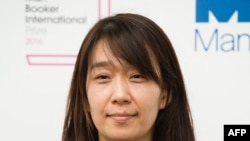 (FILES) Korean author Han Kang poses for a photograph with her book The Vegetarian at a photocall in London on May 15, 2016, ahead of the announcement of the winner of the 2016 Man Booker International Prize.