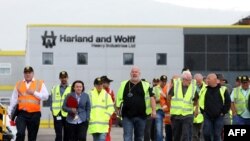 Harland and Wolff shipyard workers emerge with union reps after a meeting at the shipyard, vowing to continue their picket at the gates until their jobs are secure, in Belfast, Northern Ireland, Aug. 5, 2019. 