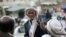 A Yemeni man, right, uses his mobile phone to take photos of his friend as they gather near the historical site of Bab al-Yemen in the the old city of Sana'a, Yemen, Nov. 14, 2012.