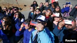 People test their special solar glasses before the solar eclipse in La Silla European Southern Observatory (ESO) at Coquimbo, Chile, July 2, 2019. 