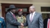 South Sudan's President Salva Kiir left, and opposition leader Riek Machar, right, shake hands after meetings Oct. 20, 2019.