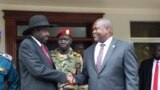 FILE - South Sudan's President Salva Kiir left, and opposition leader Riek Machar, right, shake hands after meetings Oct. 20, 2019.