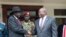 South Sudan's President Salva Kiir left, and opposition leader Riek Machar, right, shake hands after meetings Oct. 20, 2019.