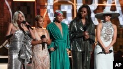 FILE - Lady Gaga, from left, Jada Pinkett Smith, Alicia Keys, Michelle Obama and Jennifer Lopez speak at the 61st annual Grammy Awards in Los Angeles, Feb. 10, 2019.