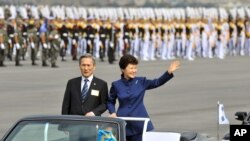 FILE - South Korean President Park Geun-hye waves as she inspects troops with Defense Minister Kim Kwan-jin during a ceremony marking the 65th anniversary of the founding of South Korea's Armed Forces, Seongnam, Oct. 1, 2013.