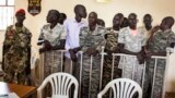 FILE - South Sudanese soldiers listen to the guilty verdict being delivered Sept. 6, 2018, at their trial for rape and murder in a violent rampage in 2016 at a Juba hotel.