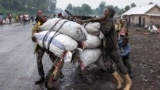 A person holds bags of potatoes from the Kibati market, on a traditional scooter (chukudu), to sell in Goma, days after the M23 rebel group seized the town of Goma, North Kivu province, in eastern Democratic Republic of the Congo, Feb. 2, 2025. 