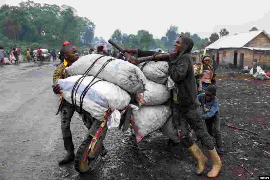 A person holds bags of potatoes on a traditional scooter (chukudu), to sell in Goma, days after the M23 rebel group seized the town in North Kivu province, in eastern Democratic Republic of the Congo.