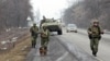 FILE - Interior Ministry officers patrol a road in the Russian North Caucasus on the hunt for Islamic State rebels, Jan. 28, 2011.