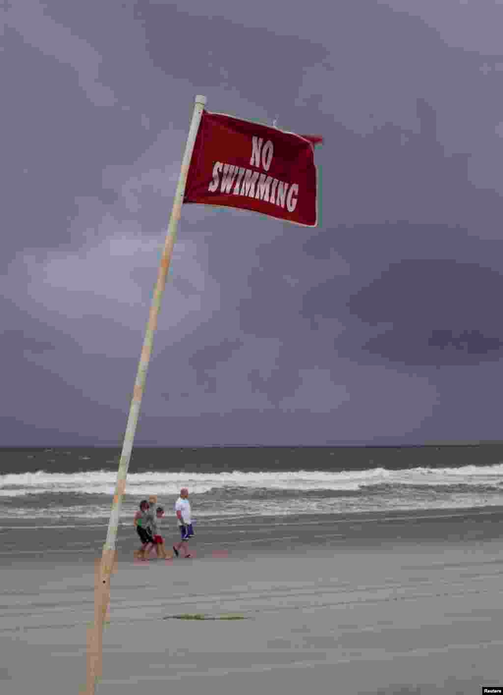 A &quot;No Swimming&quot; sign is pictured at Myrtle Beach State Park in preparation for the arrival of Hurricane Arthur, in Myrtle Beach, South Carolina, July 3, 2014.