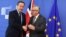 European Commission President Jean-Claude Juncker, right, greets British Prime Minister David Cameron prior to a meeting at EU headquarters in Brussels, June 28, 2016. 