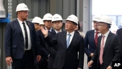 China's Premier Li Qiang, center, visits Tianqi Lithium Energy in Perth, Australia, June 18, 2024. Li is on a four-day visit to Australia. 