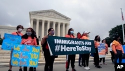 Deferred Action for Childhood Arrivals (DACA) students celebrate in front of the Supreme Court after the Supreme Court rejected President Donald Trump's effort to end legal protections for young immigrants, June 18, 2020, in Washington.