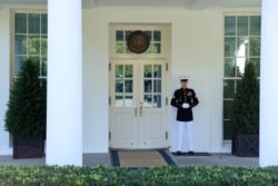 A U.S. Marine is posted at the West Wing door at the White House in Washington, Oct. 7, 2020.