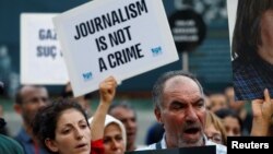 FILE - Demonstrators shout slogans during a protest against the arrest of press freedom activists, in central Istanbul, Turkey, June 21, 2016. Turkey on Tuesday arrested nine journalists across the country in connection with last month's failed coup.