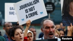 FILE - Demonstrators shout slogans during a protest against the arrest of three prominent activists for press freedom, in central Istanbul, Turkey, June 21, 2016. Arrest warrants for 42 Turkish journalists were issued Monday in connection with the failed coup July 15, 2016.